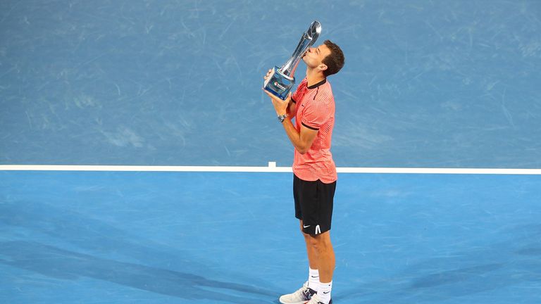 BRISBANE, AUSTRALIA - JANUARY 08:  Grigor Dimitrov of Bulgaria holds the Roy Emerson trophy after winning the Men's Final against Kei Nishikori of Japan du