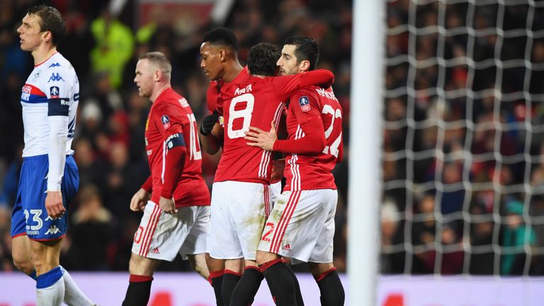 Henrikh Mkhitaryan is congratulated by team-mates after scoring United's third against Wigan