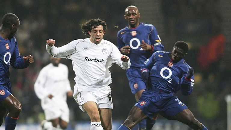 Former Bolton defender Ivan Campo surrounded by Arsenal players in a match from 2005