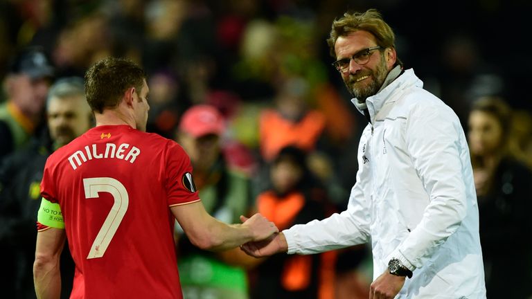 Liverpool's German head coach Jurgen Klopp (R) shakes hands with Liverpool's English midfielder James Milner after the UEFA Europe League quarter-final, fi