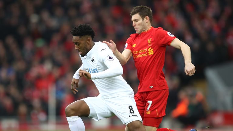 LIVERPOOL, ENGLAND - JANUARY 21: Leroy Fer of Swansea City (L) is put under pressure from James Milner of Liverpool (R) during the Premier League match bet
