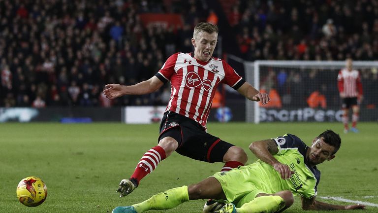 Liverpool's Croatian defender Dejan Lovren (R) tackles Southampton's English midfielder James Ward-Prowse during the EFL (English Football League) Cup semi