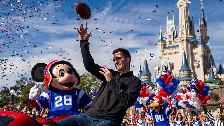 LAKE BUENA VISTA, FL - FEBRUARY 04:  In this handout photo provided by Disney Parks, Super Bowl XLVII MVP Joe Flacco rides with Mickey Mouse in a parade th