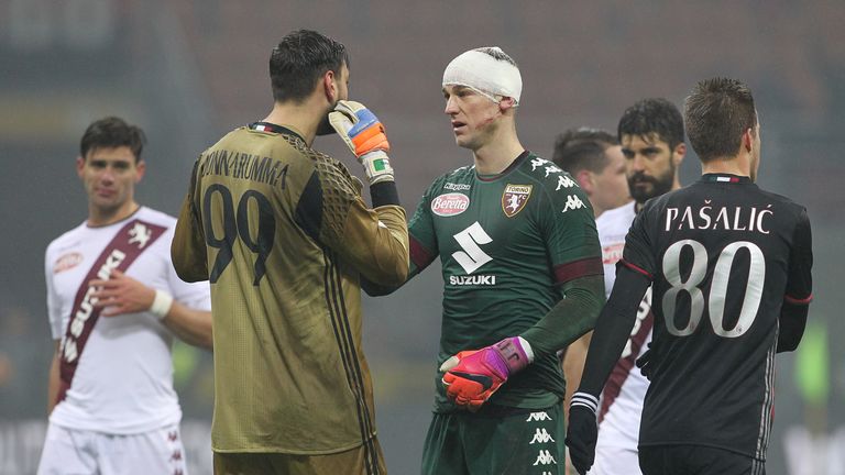 MILAN, ITALY - JANUARY 12:  Gianluigi Donnarumma #99 of AC Milan speaks to Joe Hart #21 of Torino FC at the end of the TIM Cup match between AC Milan and A