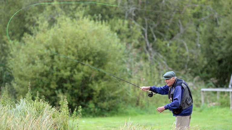 LECKFORD, ENGLAND - SEPTEMBER 13:  John Jacobs of England the legendary Golf Coach enjoying his favourite pastime fly fishing for trout at The Leckford Est