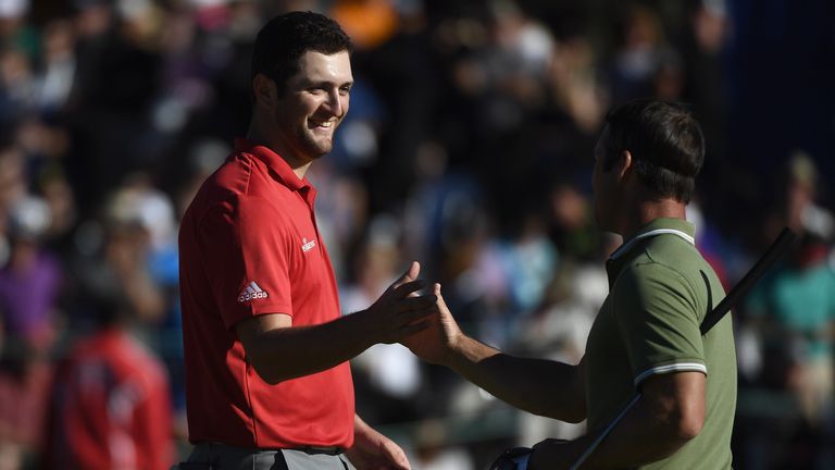 John Rahm of Spain shakes hands with Ollie Schniederjans on the 18th hole during the final round of the Farmers Insurance Open 