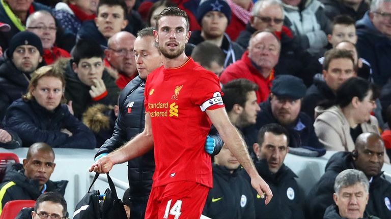 Liverpool skipper Jordan Henderson leaves the pitch after suffering injury against Manchester City