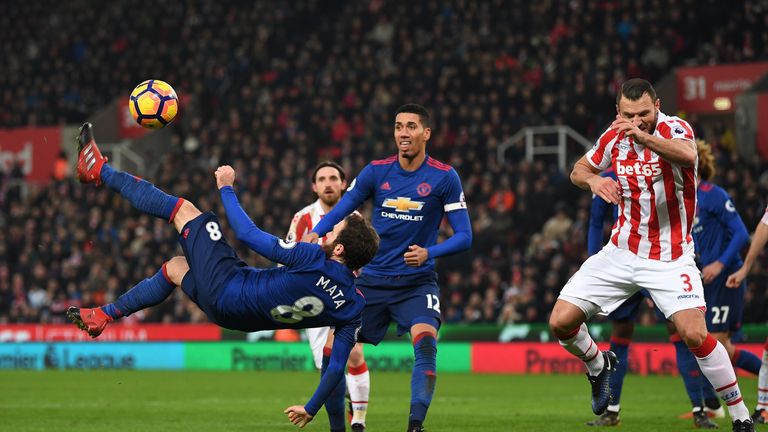STOKE ON TRENT, ENGLAND - JANUARY 21: Juan Mata of Manchester United (L) attempts a overhead kick during the Premier League match between Stoke City and Ma