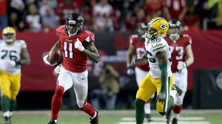 ATLANTA, GA - JANUARY 22:  Julio Jones #11 of the Atlanta Falcons looks to avoid the tackle attempt of LaDarius Gunter #36 of the Green Bay Packers during 