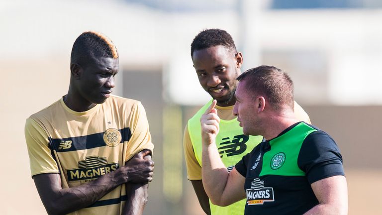 Brendan Rodgers with Kouassi Eboue (left) and Moussa Dembele in Dubai