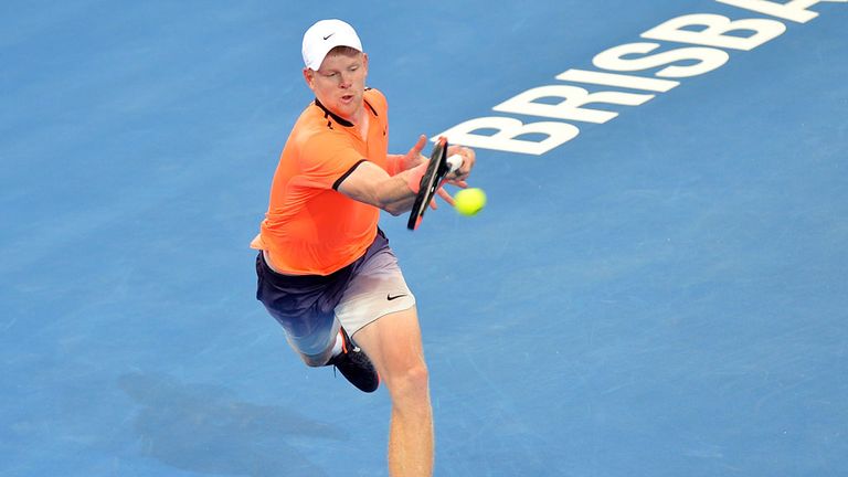 Kyle Edmund returns a shot from Stan Wawrinka