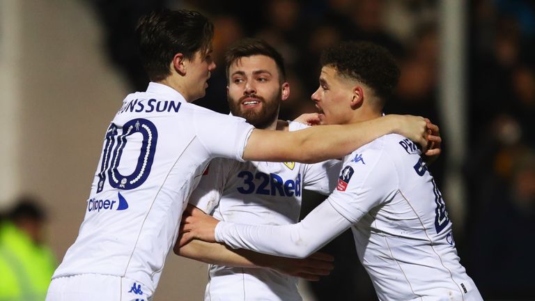 Stuart Dallas of Leeds United (C) celebrates with Marcus Antonsson (L) and Kalvin Phillips (R) as he scores their equaliser against Cambridge