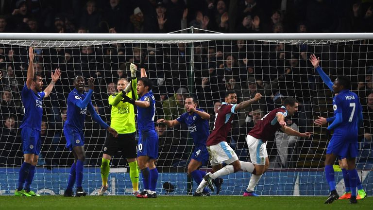 Sam Vokes celebrates scoring the opening goal while Leicester City players appeal to referee Mike Dean