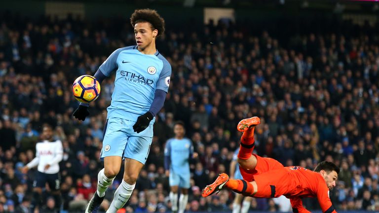MANCHESTER, ENGLAND - JANUARY 21:  Leroy Sane of Manchester City (C) gets to the ball before Hugo Lloris of Tottenham Hotspur (R) and goes on to score his 