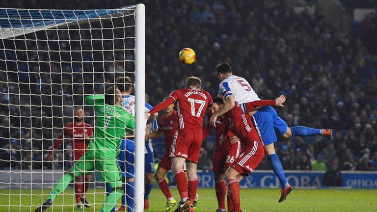 Lewis Dunk of Brighton and Hove Albion (5) jumps with Aron Gunnarsson (17) and Sean Morrison of Cardiff City (4) during the Sky Bet Championship clash
