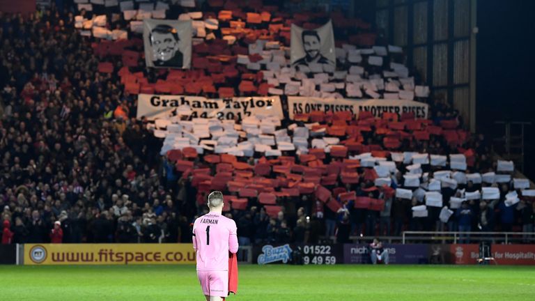 Fans, players and officals pay tribute to Graham Taylor prior to kick off  during the Emirates FA Cup third round replay between Lincoln and Ipswich