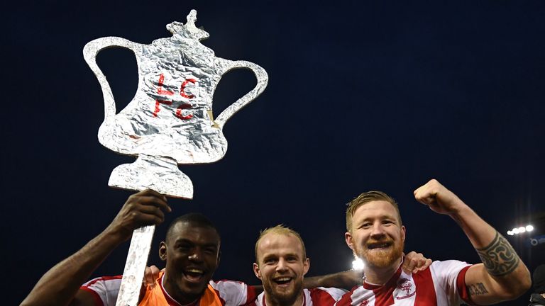 Lincoln City players celebrate their 3-1 win after Brighton in the FA Cup fourth round