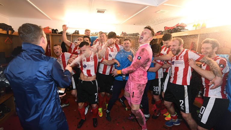 Lincoln players celebrate their win in the changing room after beating Brighton in the FA Cup fourth round