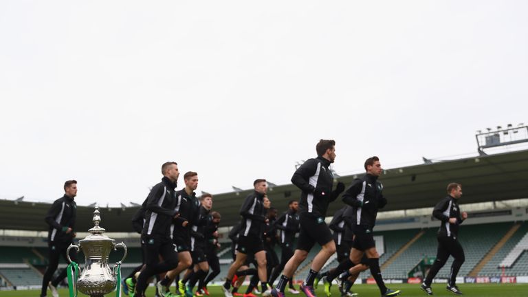 The Plymouth players jog past a replica FA Cup trophy during the Plymouth Argyle Media Access ahead of the clash at Liverpool