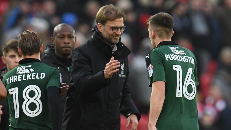 Liverpool manager Jurgen Klopp (C) congratulates Plymouth's players at full-time