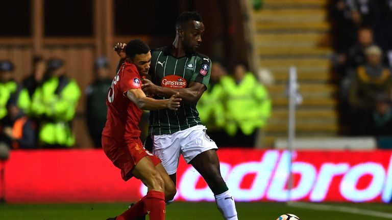 Liverpool's English midfielder Trent Alexander-Arnold (L) vies with Plymouth's English striker Jordan Slew during the English FA Cup third round replay foo