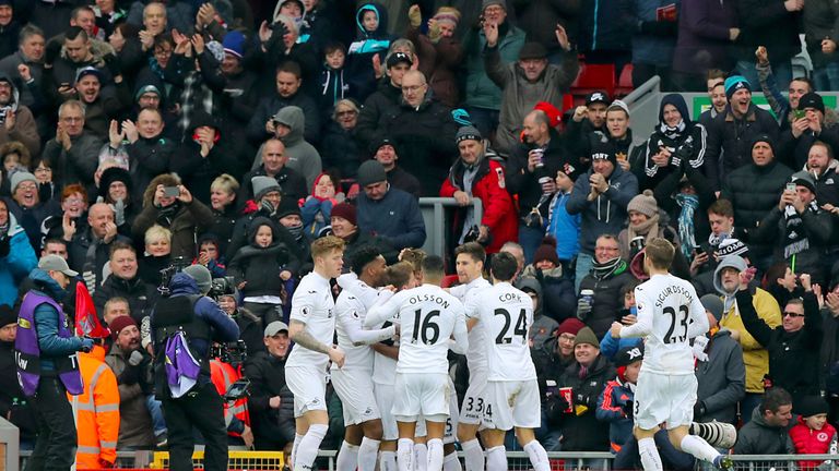 Fernando Llorente is mobbed after opening the scoring at Anfield