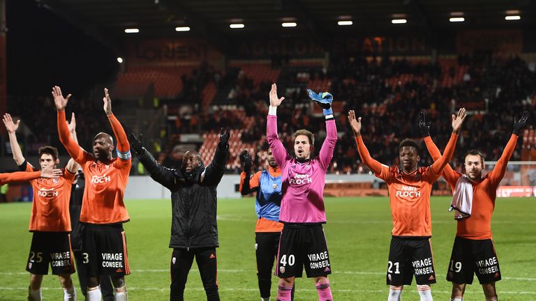 Lorient's players celebrate with their supporters at the end of the French L1 football match between Lorient and Guingamp on January 14, 2017 at the Mousto