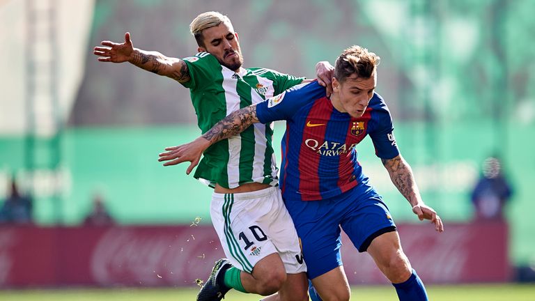 SEVILLE, SPAIN - JANUARY 29: Dani Ceballos of Real Betis Balompie (L) competes for the ball with Lucas Digne of FC Barcelona (R) during the La Liga match b