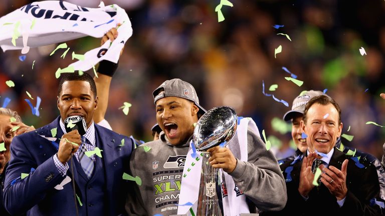 EAST RUTHERFORD, NJ - FEBRUARY 02:  Outside linebacker and Super Bowl MVP Malcolm Smith #53 of the Seattle Seahawks holds the Vince Lombardi Trophy after w