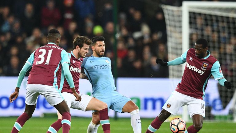 Manchester City's Argentinian striker Sergio Aguero (2nd R) passes the ball as he's surrounded by West Ham players during the English FA cup third round fo