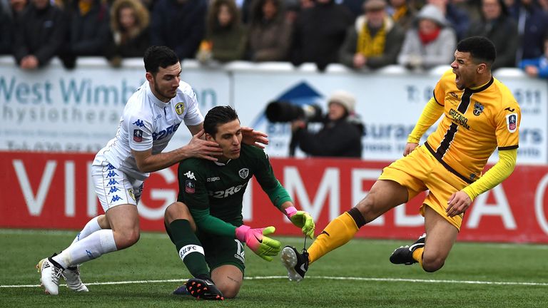 Marco Silvestri and Lewie Coyle tussle with Maxime Biamou in the incident that prompted the penalty 