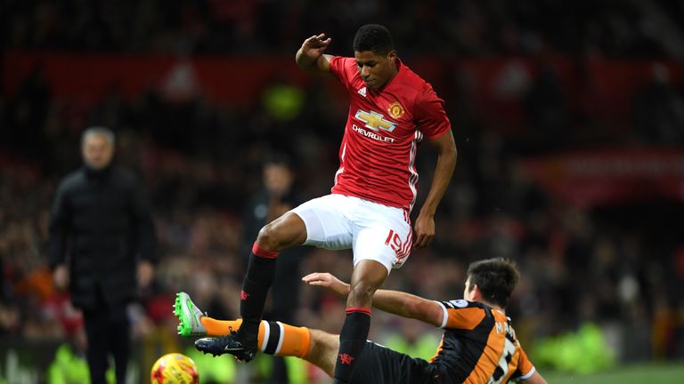 Marcus Rashford of Manchester United rides a tackle from Harry Maguire of Hull City 