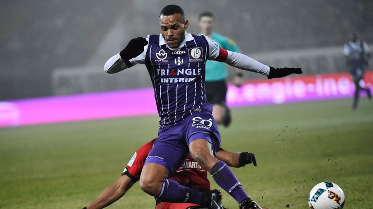 Toulouse's Danish forward Martin Braithwaite (R) is tackled by Dijon's French defender Yunis Abdelhamid during the French L1 football match between Dijon (