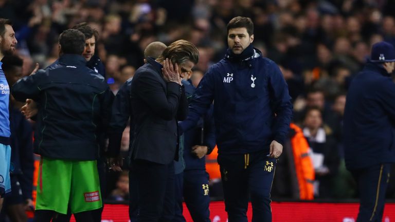 Mauricio Pochettino looks to console his opposite number Gareth Ainsworth after the final whistle at White Hart Lane