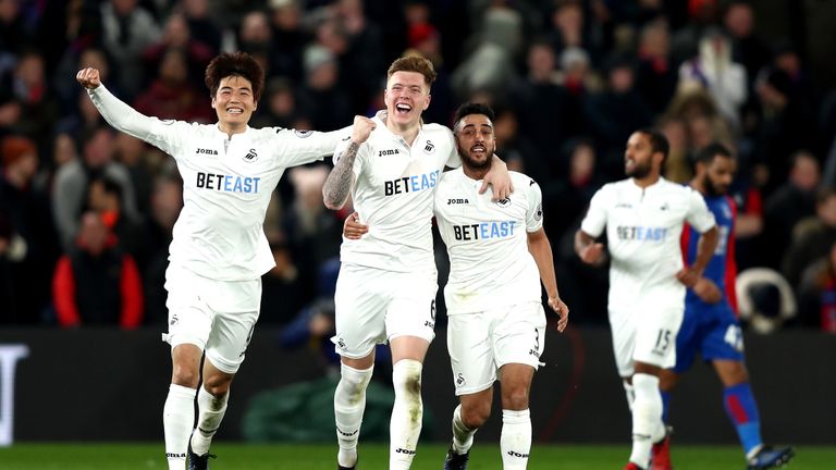 LONDON, ENGLAND - JANUARY 03: Alfie Mawson (2nd L) of Swansea City celebrates scoring the opening goal with his team mates Ki Sung-Yueng (L) and Neil Taylo