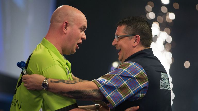 Michael van Gerwen (L) is congratulated by Gary Anderson after his victory in the PDC World Championship darts final at Alexandra Palace