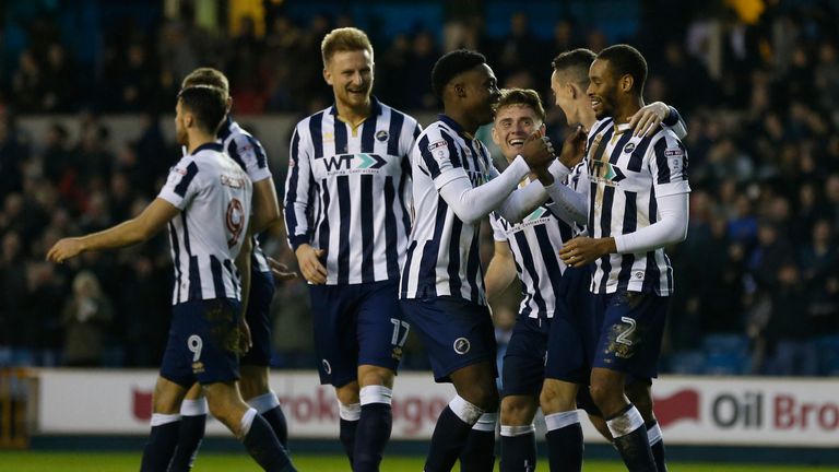 Millwall's English-born Jamaican defender Shaun Cummings (R) celebrates with teammates after scoring their second goal during the English FA Cup third roun