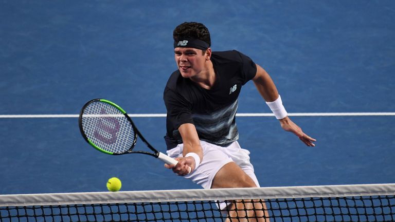 Canada's Milos Raonic hits a return against Spain's Roberto Bautista Agut during their men's singles fourth round match on day eight of the Australian Open