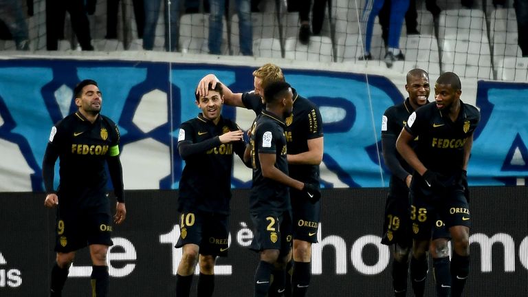 Monaco's midfielder Be Mota Veiga de Carvalho E Silva (2ndL) is congratulated by teammates after scoring a goal during the French L1 football match Marseil