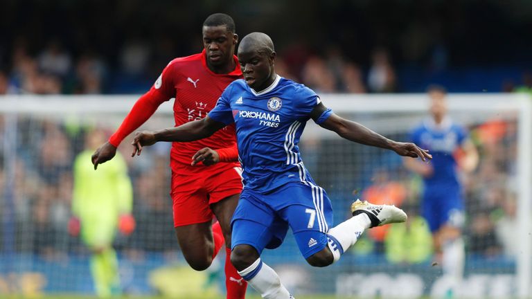 Chelsea's French midfielder N'Golo Kante (R) vies with Leicester City's Ghanaian striker Jeff Schlupp during the English Premier League football match betw