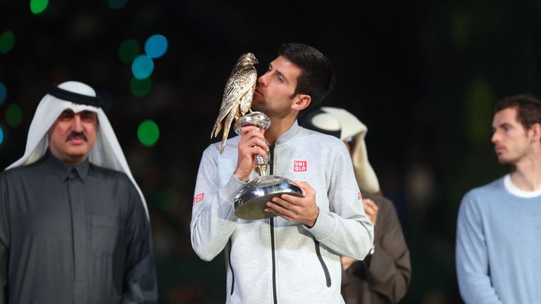 Serbia's Novak Djokovic poses with the winner's trophy after beating Britain's Andy Murray during their final tennis match at the ATP Qatar Open in Doha on