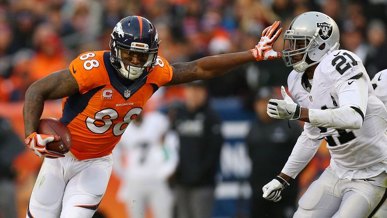 DENVER, CO - JANUARY 1:  Wide receiver Demaryius Thomas #88 of the Denver Broncos catches a pass and stiff arms cornerback Sean Smith #21 of the Oakland Ra