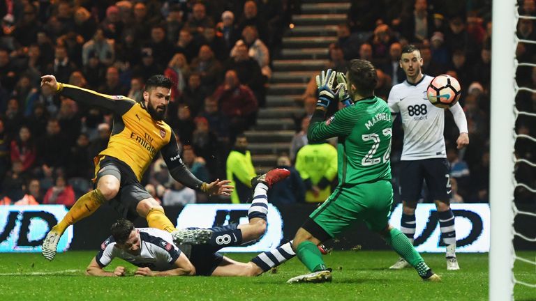 PRESTON, ENGLAND - JANUARY 07:  Olivier Giroud of Arsenal (L) shoots past Chris Maxwell of Preston North End to score their second goal during the Emirates