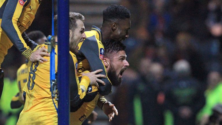 Arsenal striker Olivier Giroud (R) celebrates with team-mates after scoring the winner against Preston in the FA Cup third round