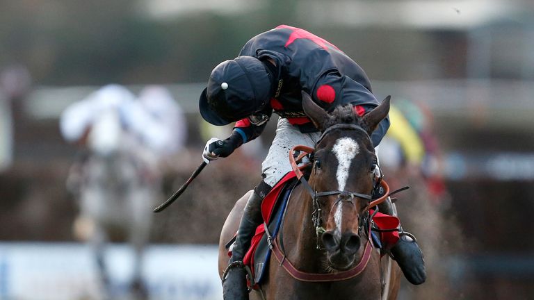 Derek Fox looks for dangers as One For Arthur comes home clear in the Classic Chase at Warwick.