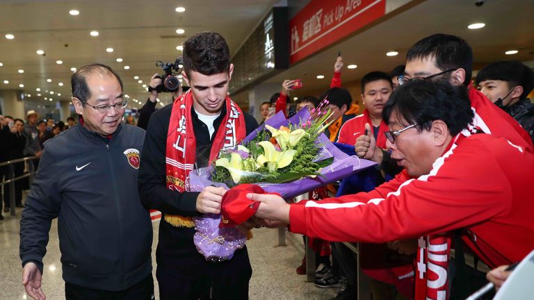 Oscar signs autographs for Shanghai SIPG fans as he arrives in China.