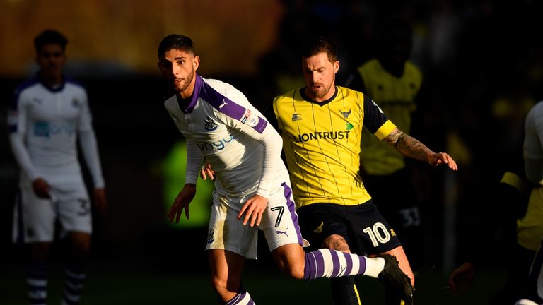 Achraf Lazaar of Newcastle United and Chris Maguire of Oxford United compete for the ball 