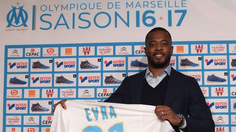 Patrice Evra poses with his shirt during a press conference at Olympique de Marseille's training ground