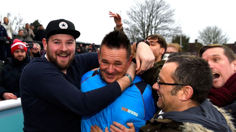 Paul Doswell is mobbed by fans after Sutton's historic FA Cup win over Leeds