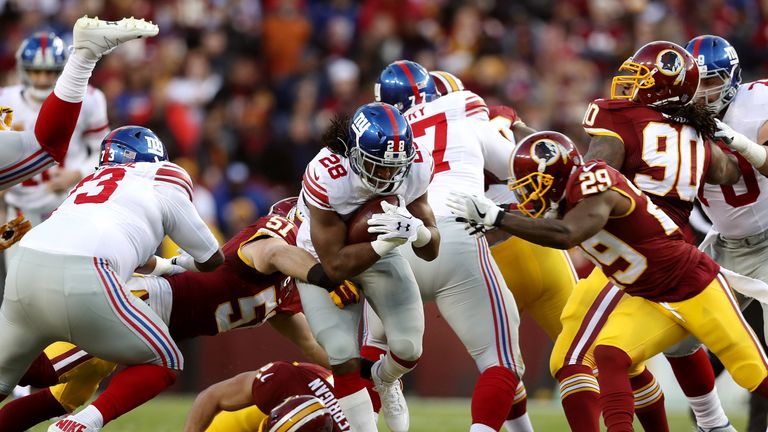 LANDOVER, MD - JANUARY 01: Running back Paul Perkins #28 of the New York Giants is tackled by inside linebacker Will Compton #51 of the Washington Redskins